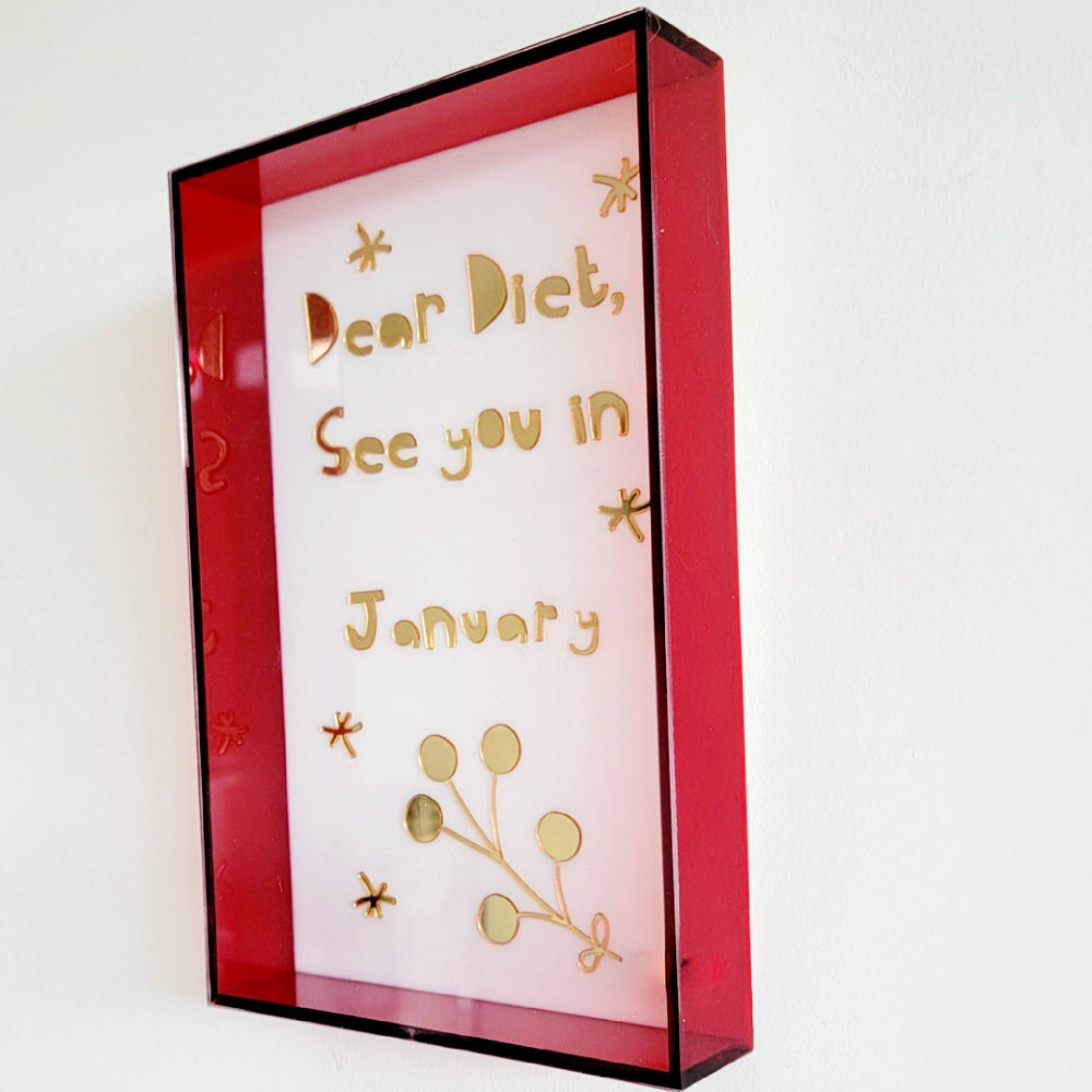 Framed message on a white wall with red border diet