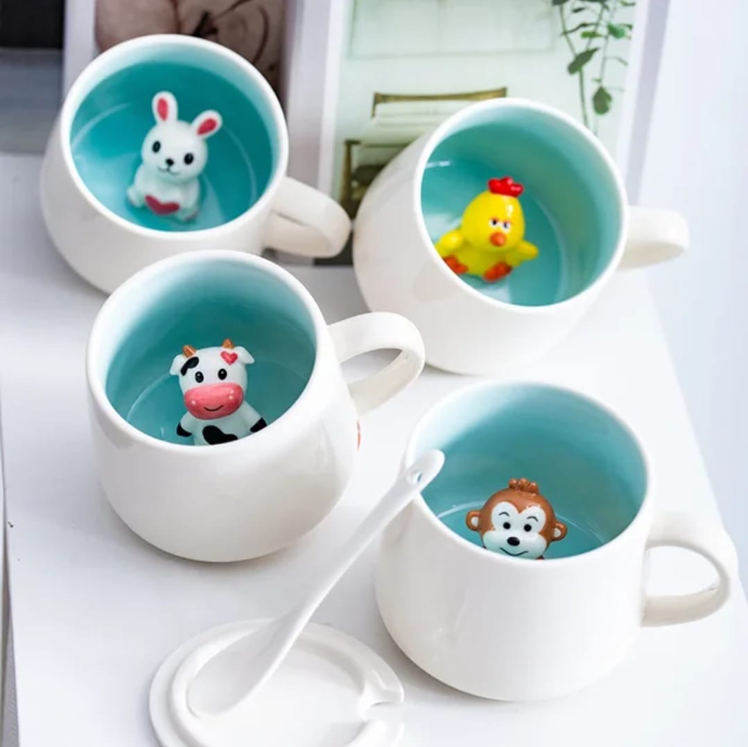 white ceramic mugs with colorful animal figures inside
