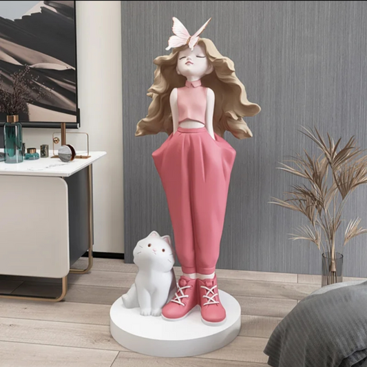 Decorative statue of a girl with pink outfit and white cat on a stand 