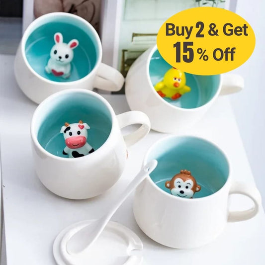Four white ceramic cups with lids and spoons containing a small cartoon animal figure