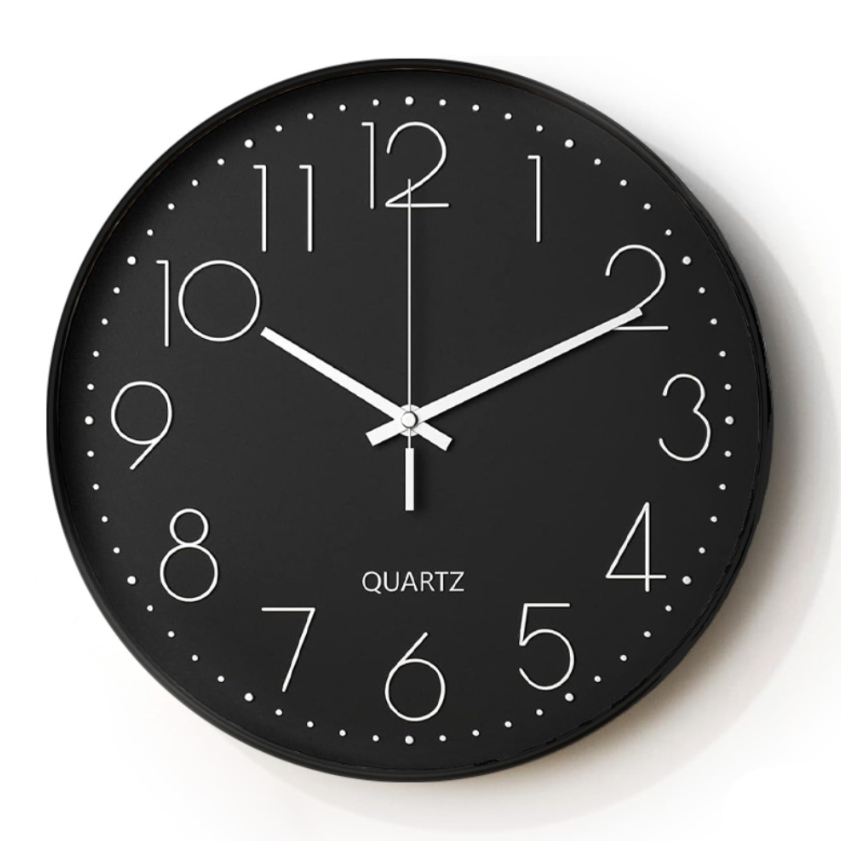 Black wall clock with white numbers and hands on a white background